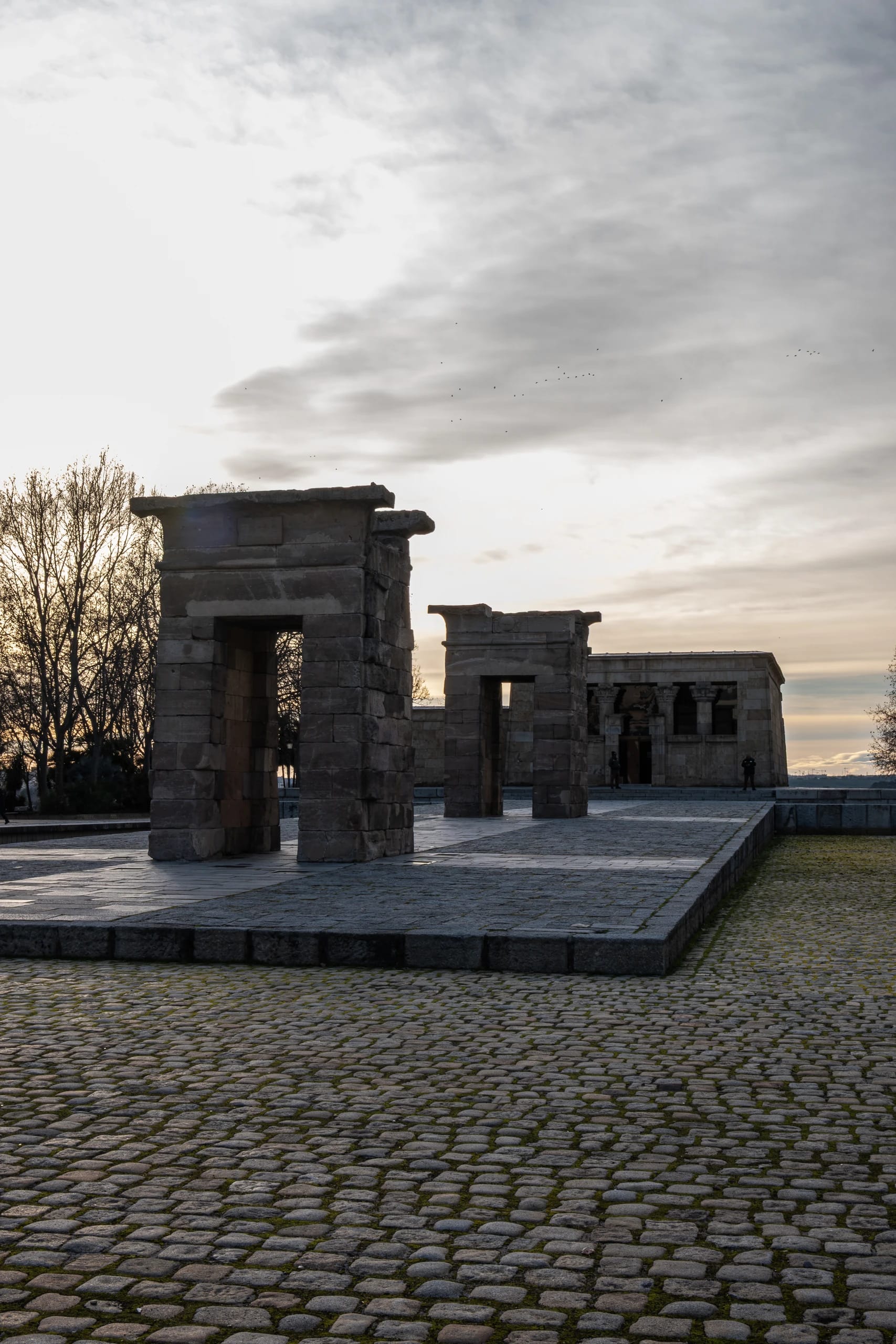 Stone temple gateways beneath a winter evening sky