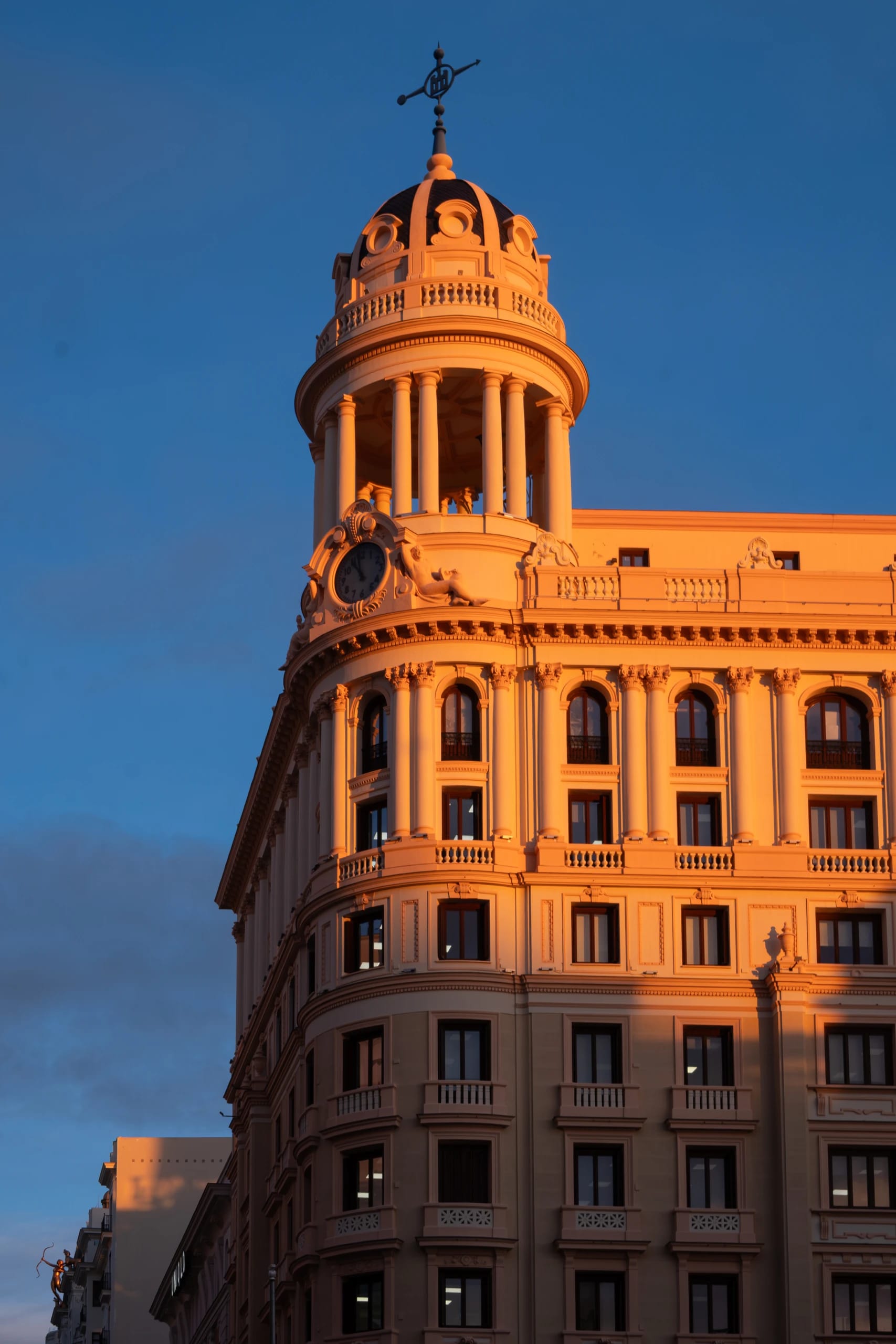 Warm evening sunlight across an ornate corner building