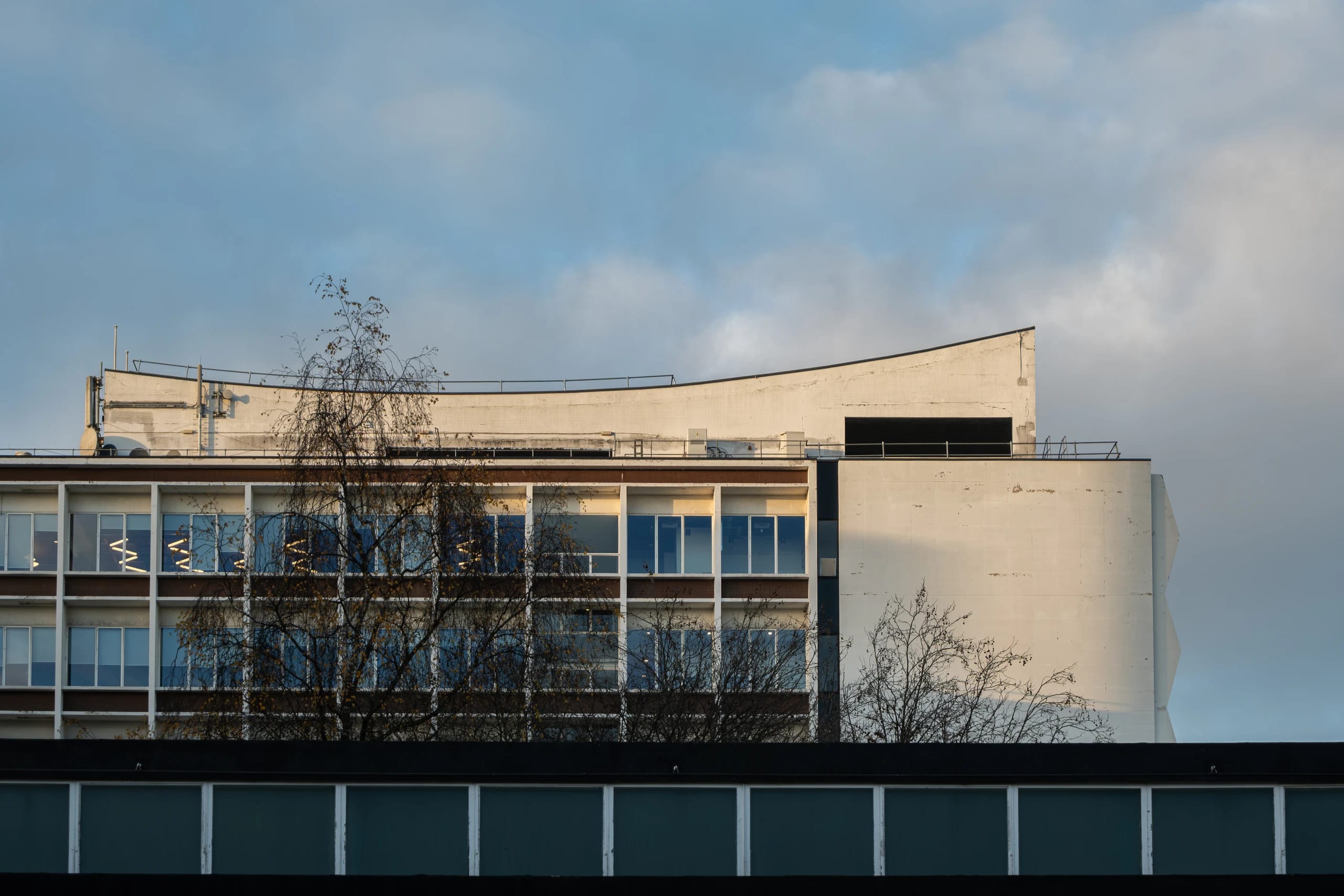 Winter light on a modernist building with a curved roofline in Manchester