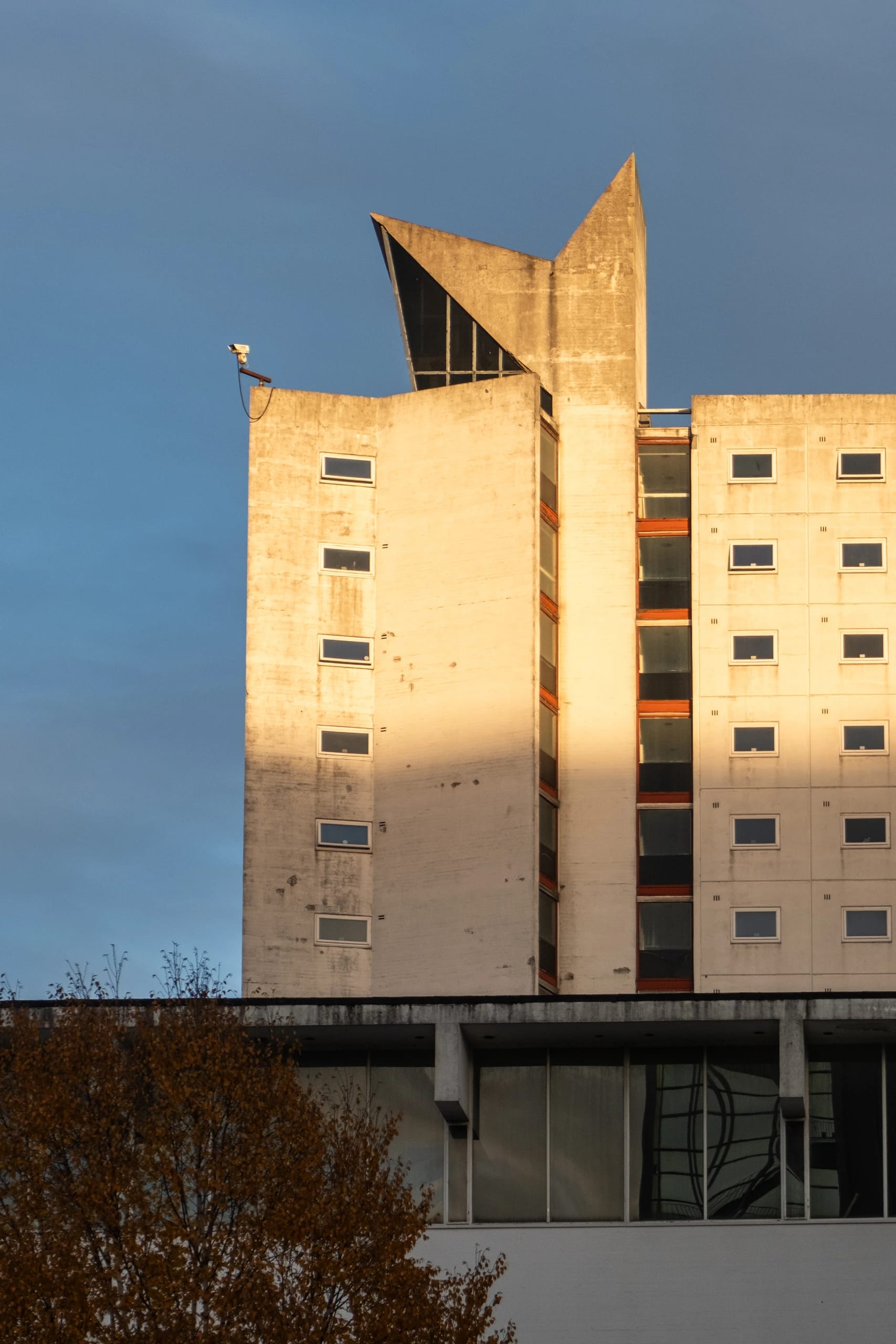 Sunlit concrete tower with an angular roof profile