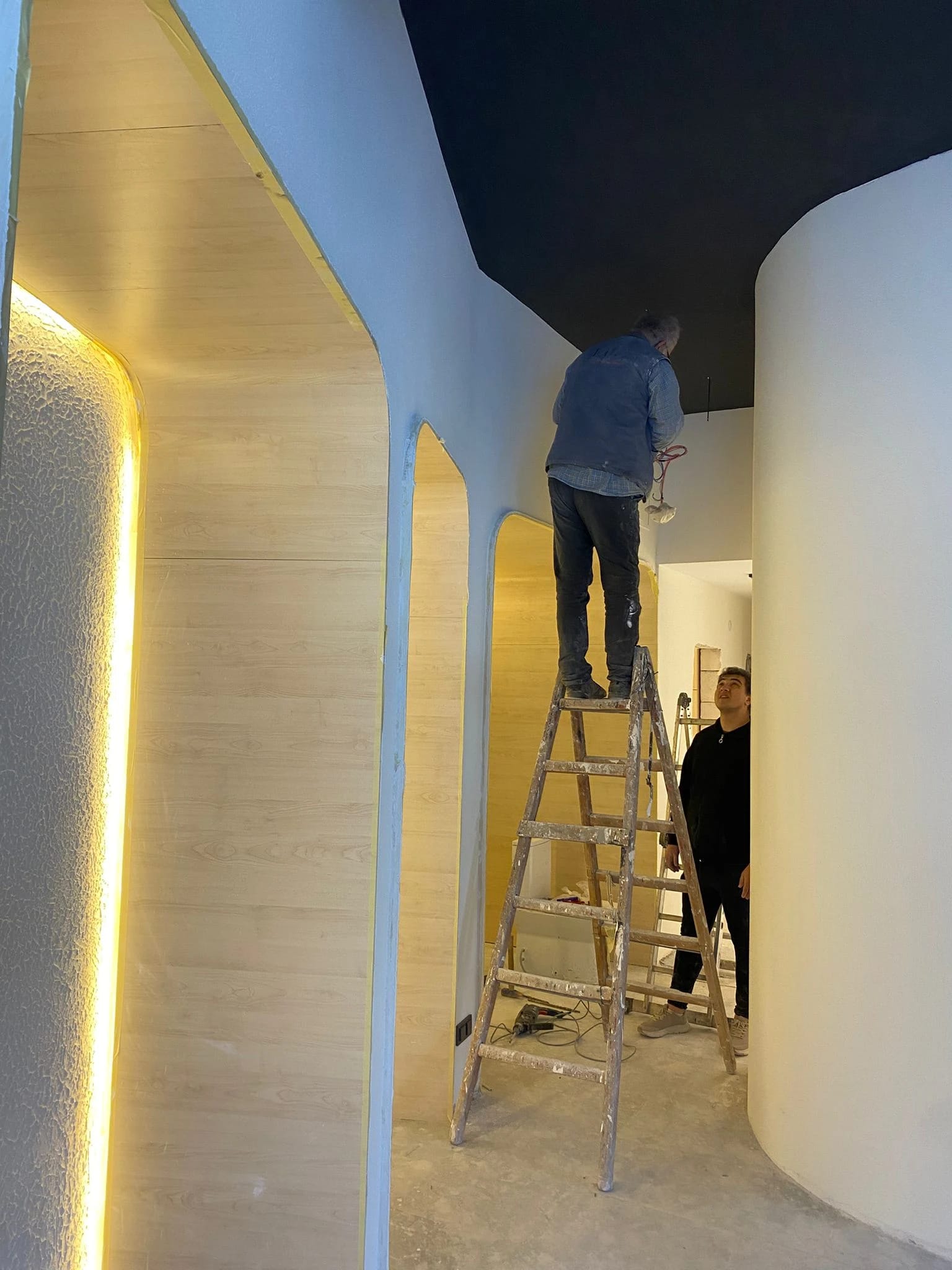 Installing lighting within the niches.