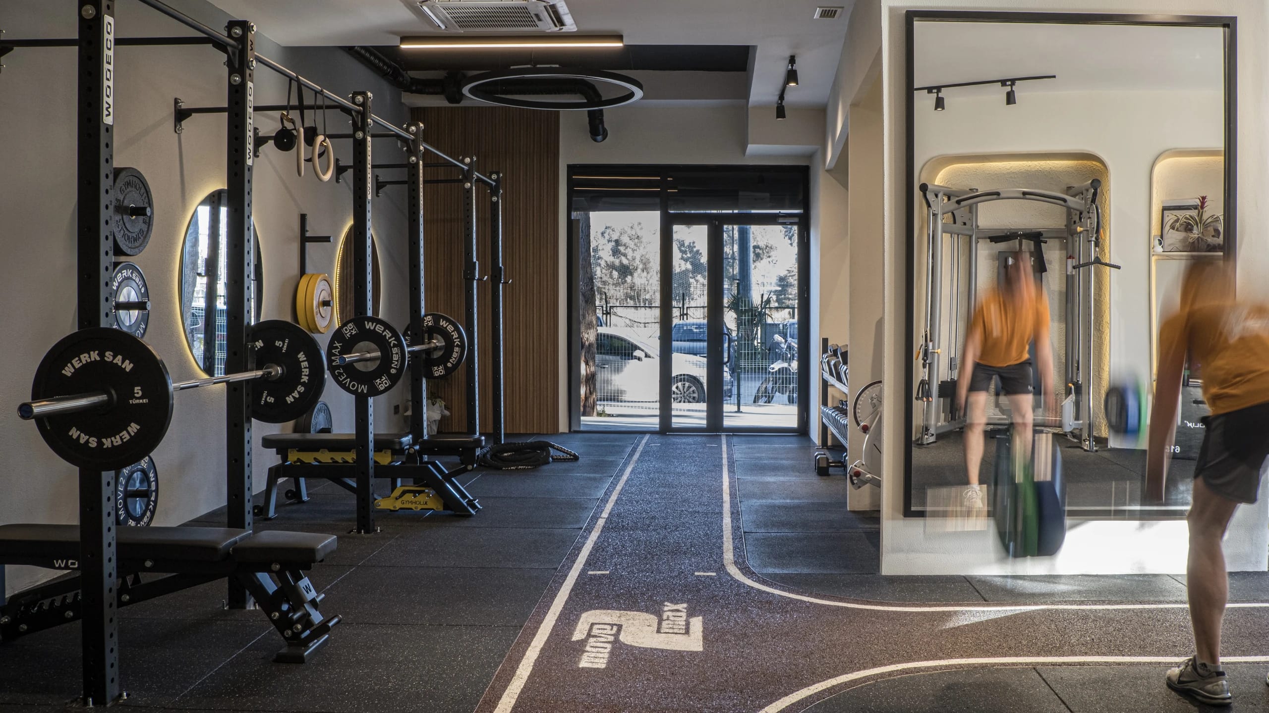 Move 2 Max Studio gym interior with training equipment, mirrors and warm lighting